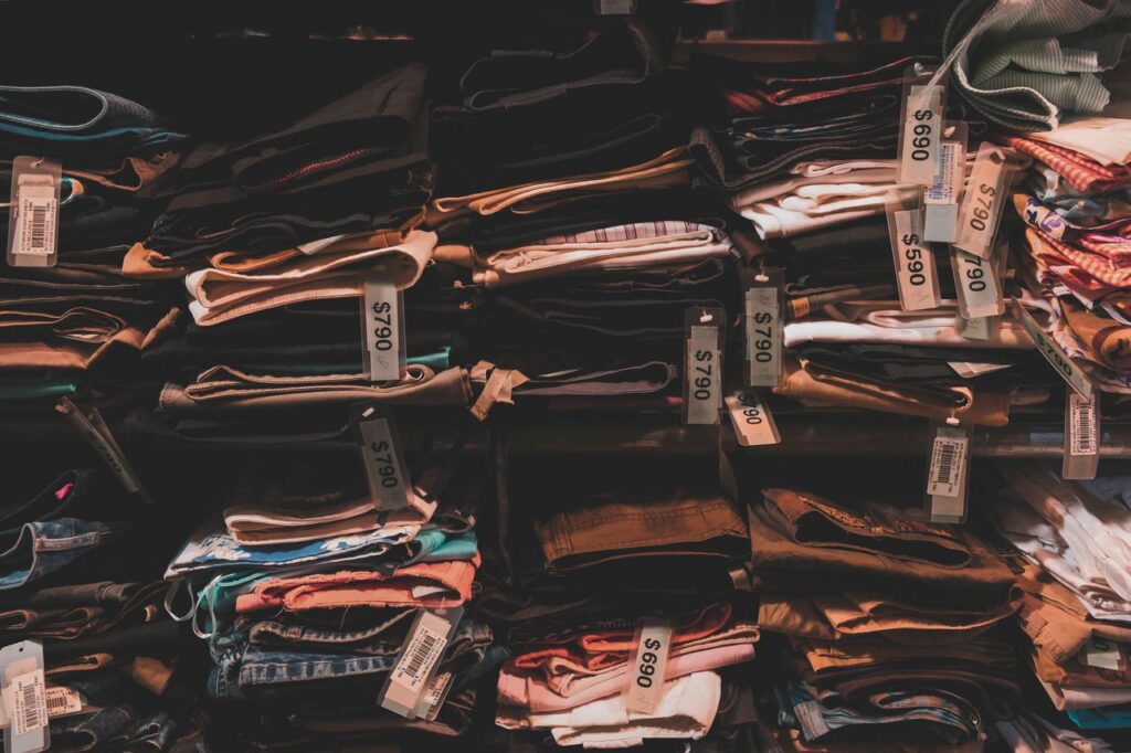 Neatly folded clothes with price tags on shelves in a Taipei shop.