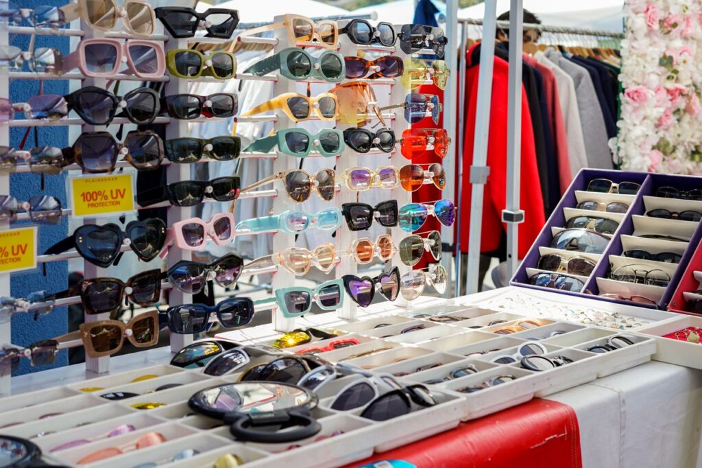 Eye-catching display of colorful sunglasses at an outdoor market stall offering stylish accessories.
